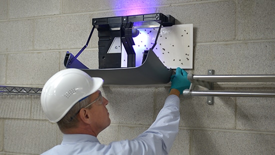 Ecolab LED Fly Light being serviced by an Ecolab Service Specialist