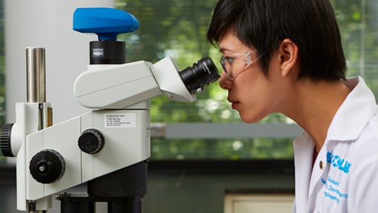 Female Scientist Looking in Microscope