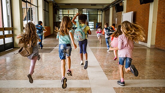Students running down a hallway