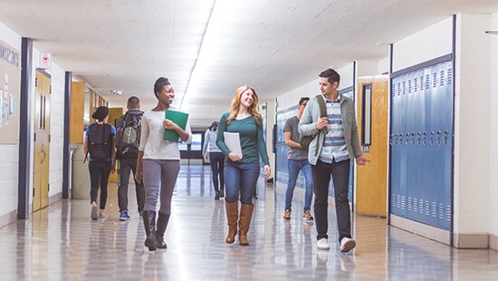 Students walking down a hallway in a high school