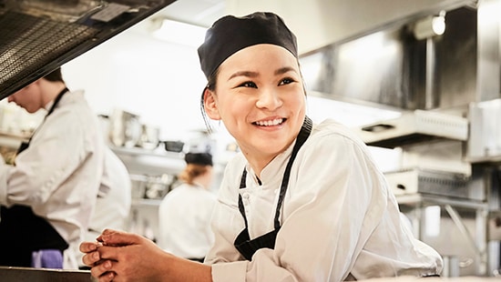 Smiling chef in the restaurant market