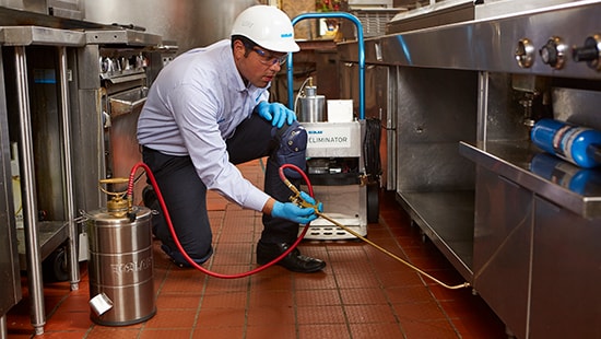 Ecolab Pest expert exterminating a commercial kitchen