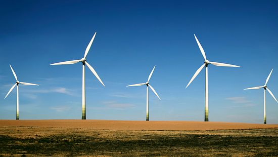 Wind turbines producing energy in field - Ecolab